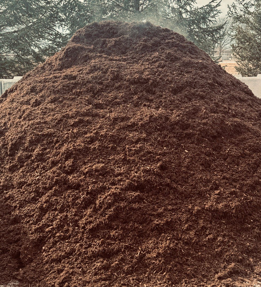 Large pile of triple ground natural mulch at Raney Tree Care in Moline, IL, available for pickup and delivery in the Quad Cities.