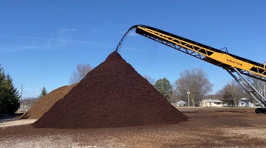 Raney Tree Care mulch supplier yard showing various types of premium mulch available for Quad Cities delivery