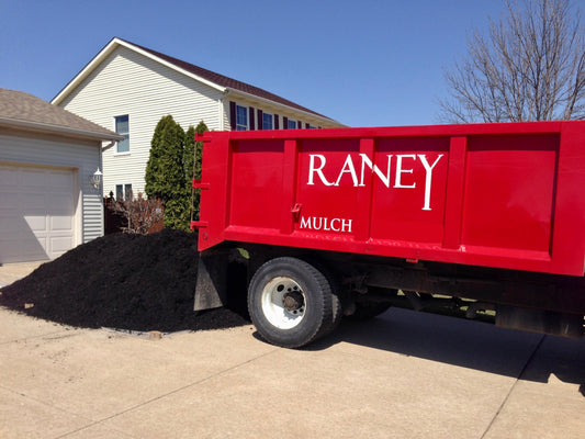 Premium bulk mulch delivery truck from Raney Tree Care serving Moline Illinois and Quad Cities area